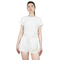 Woman wearing white relaxed shorts with 'Op Lady' embroidery and matching white t-shirt