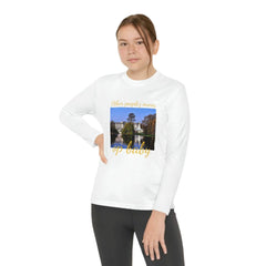 Youth wearing white long sleeve t-shirt with palace graphic and gold text, urban streetwear style